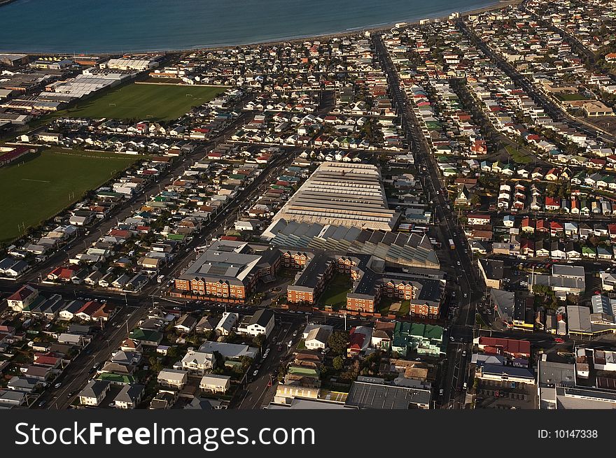 A resthome/hospital and bus depot sit in the middle of a residential area with a school nearby. A resthome/hospital and bus depot sit in the middle of a residential area with a school nearby