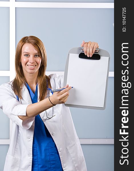 Female doctor holding blank chart in modern hospital