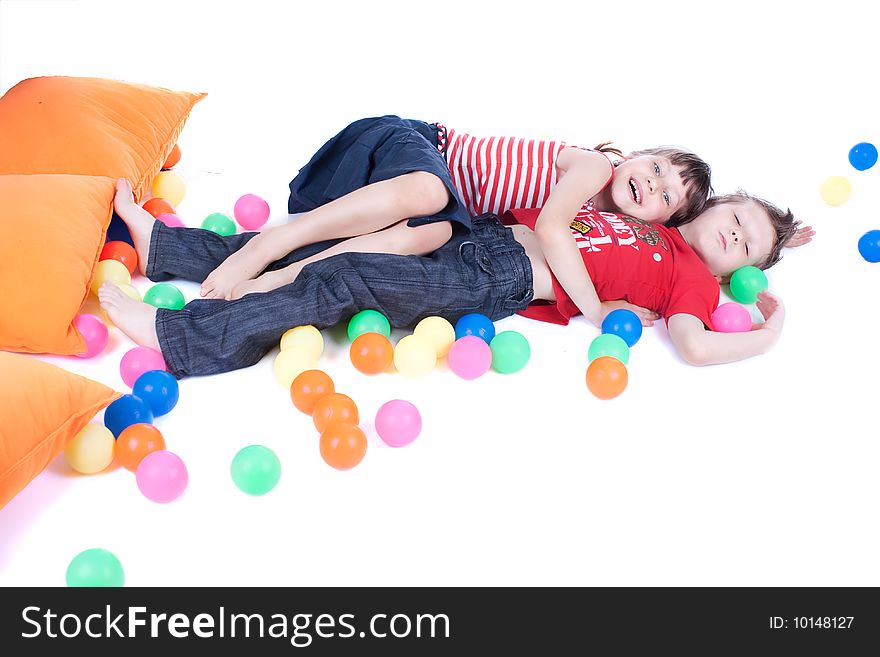 A lovely kids are playing with balls, studio shot