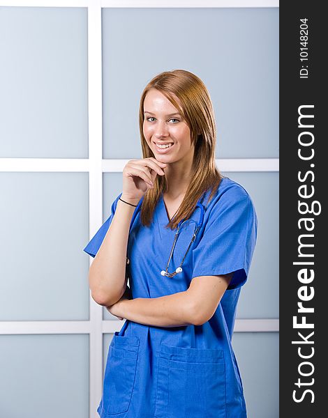 Nurse thinking in a modern office at desk