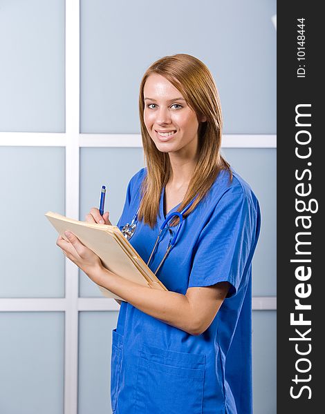 Female Nurse in a modern office holding a chart