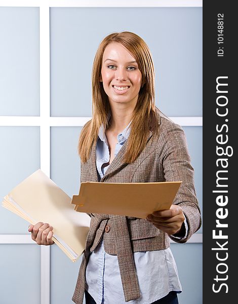 Business woman holding legal documents in modern office
