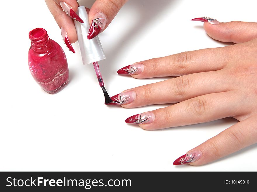 Woman applying red nail polish. Woman applying red nail polish