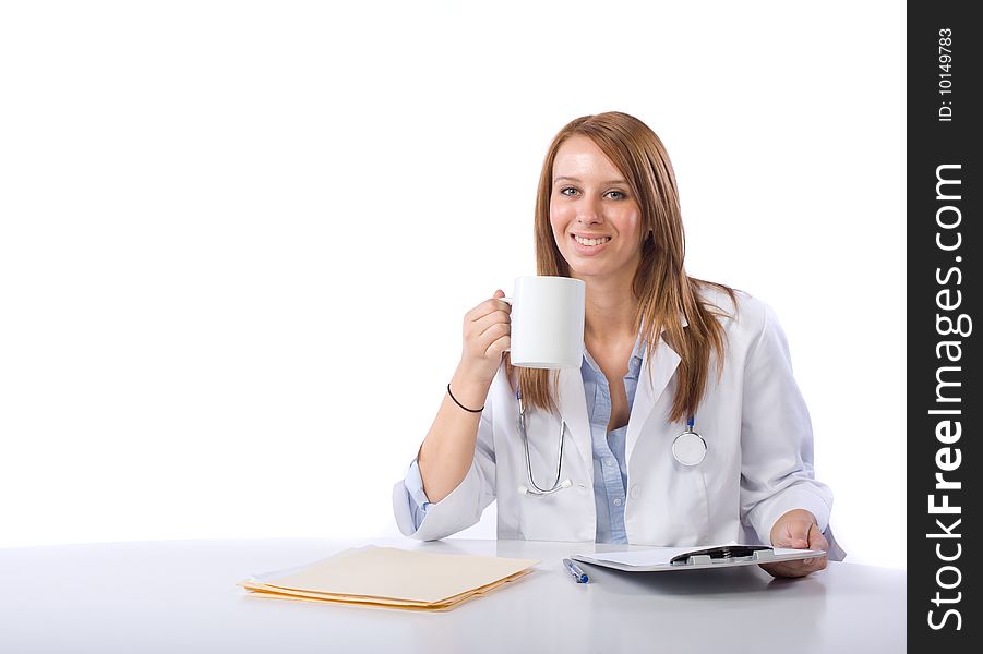 Female doctor in a modern office drinking coffee