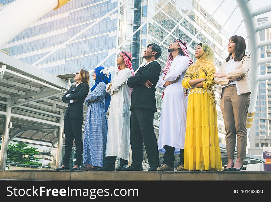 Multiethnic group of businesspeople meeting outdoors in a city background.