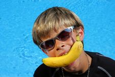Boy With Sun Glasses, T-shirt And A Banana Royalty Free Stock Photo
