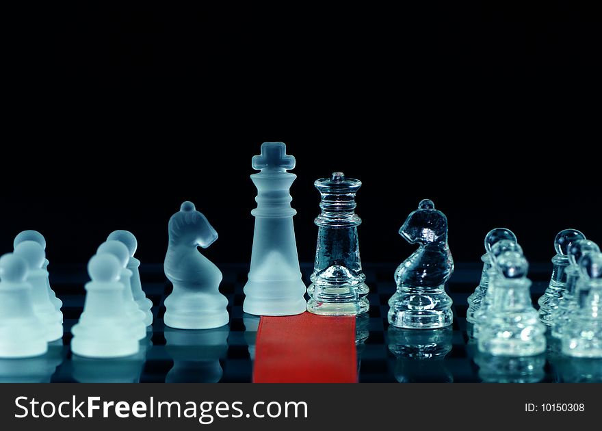 Chess and red ribbon on chess board with black background