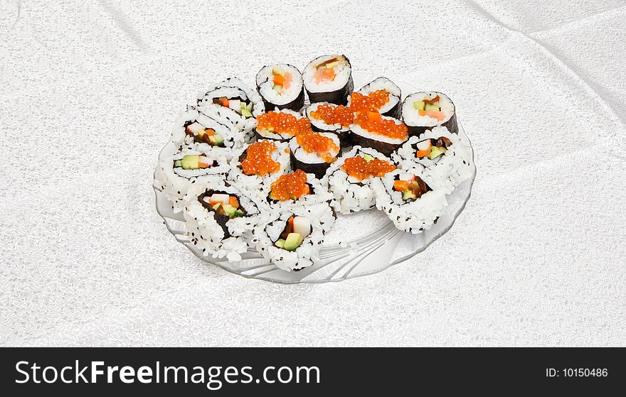 Homemade sushi of several types with red caviar on glass plate. Homemade sushi of several types with red caviar on glass plate