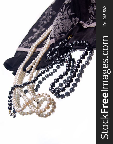 White and black pearl beads on black silk. White and black pearl beads on black silk