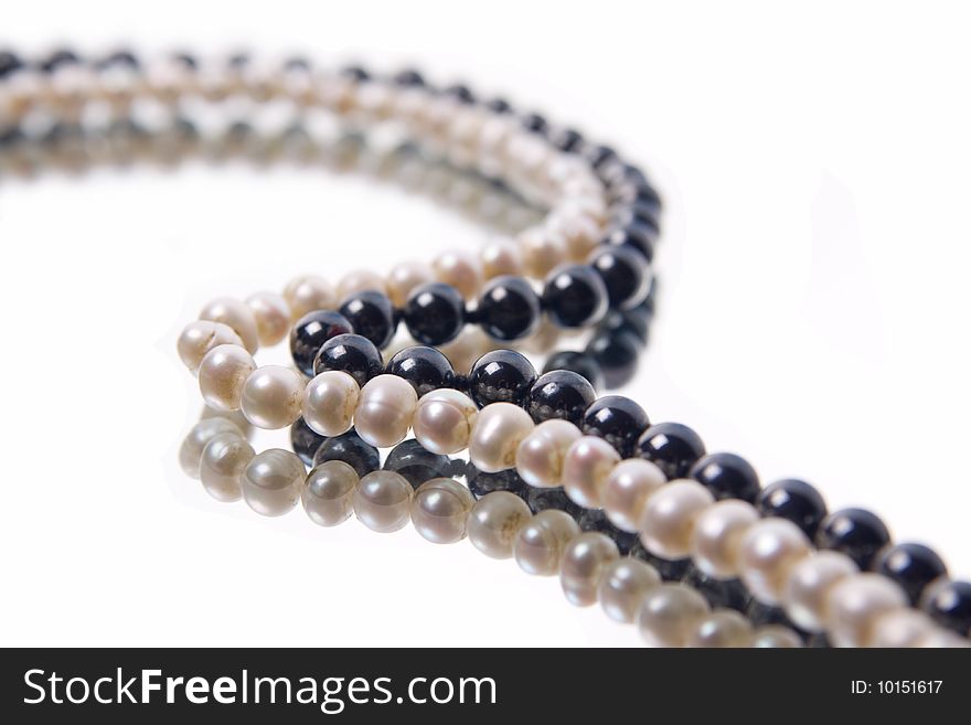 White and black pearl beads on white background