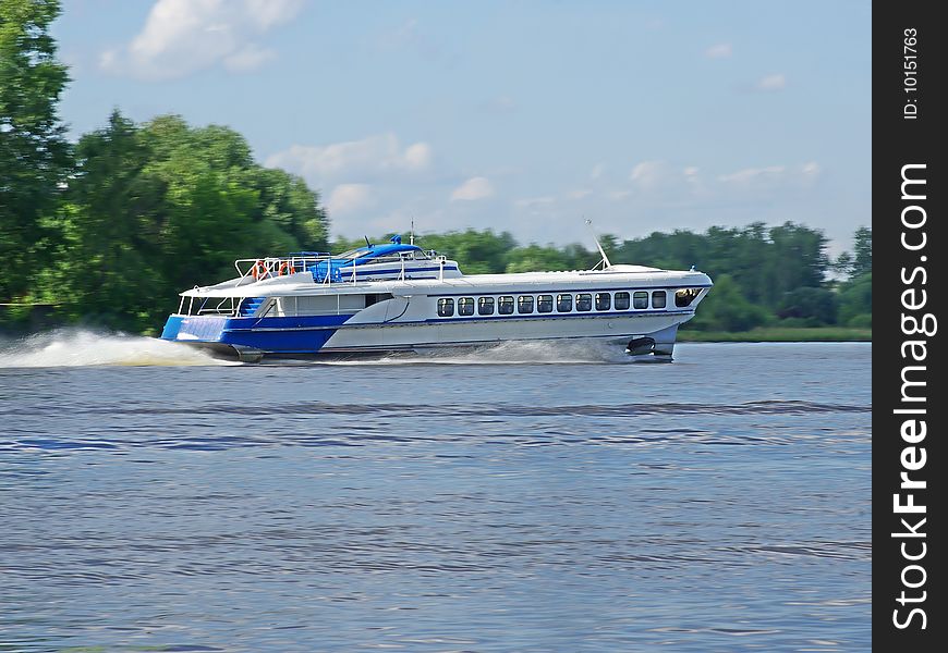High- speed passenger hydrofoil sheep flies on the river. High- speed passenger hydrofoil sheep flies on the river