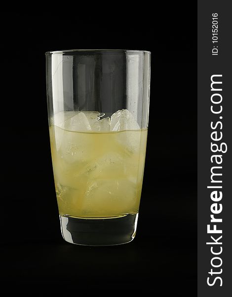 Soft drink tumbler glass on black background