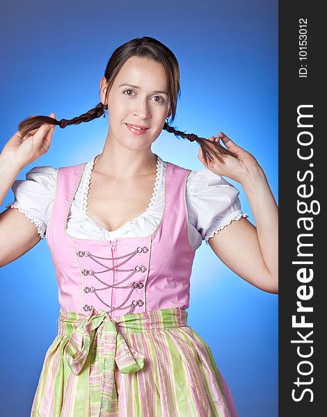 A young woman dressed in a traditional Bavarian Dirndl. A young woman dressed in a traditional Bavarian Dirndl.