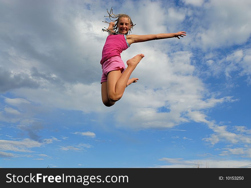 Young girl jump high up.