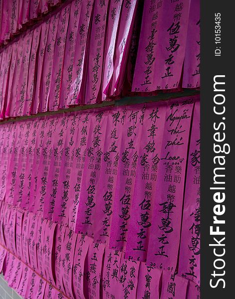 Prayer flags or prayer slips, black Chinese characters on pink tissue paper, at Chua Thien Hau Temple in Cho Lon, Ho Chi Minh Sity, Vietnam. Prayer flags or prayer slips, black Chinese characters on pink tissue paper, at Chua Thien Hau Temple in Cho Lon, Ho Chi Minh Sity, Vietnam.