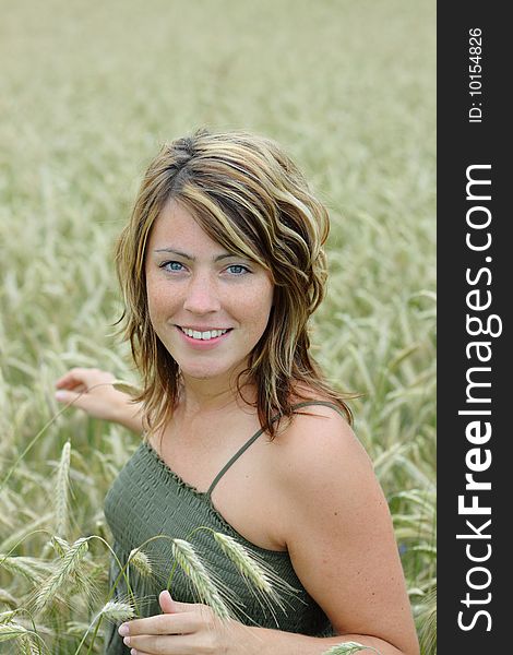 Woman walking in cornfield in summer