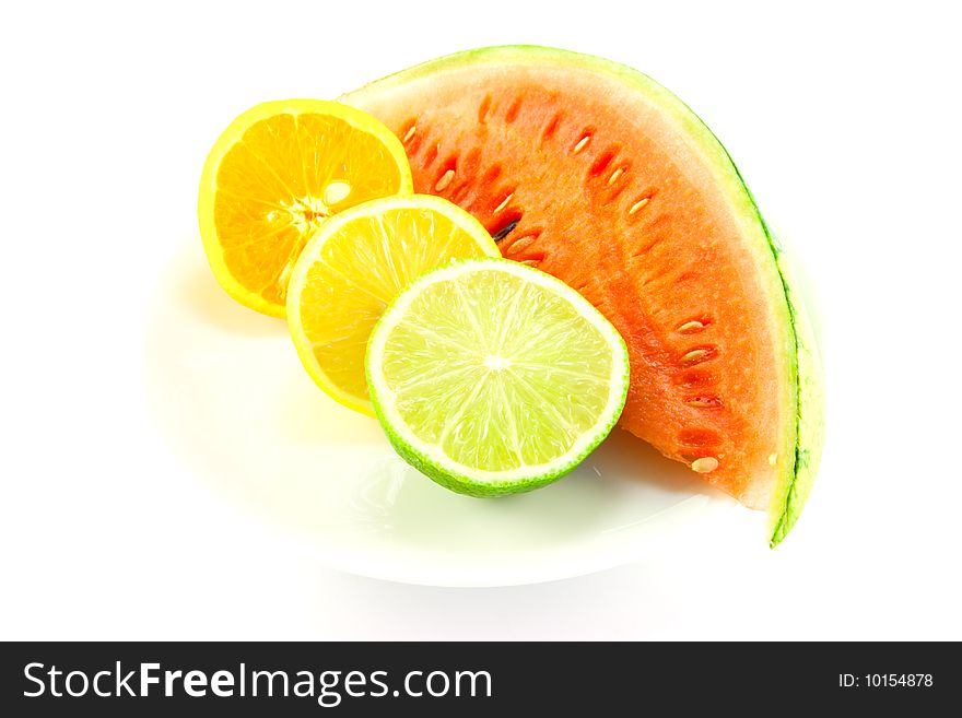 Slice of juicy watermelon with lemon, lime and orange halves on a white background