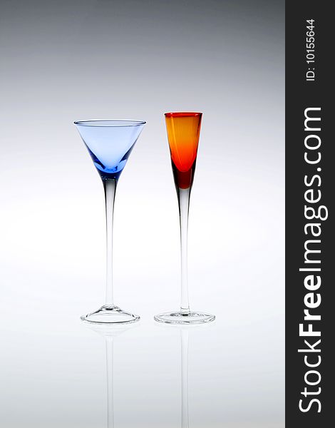 Blue and orange cordial, aperitif or liqueur glasses, empty. Blue and orange cordial, aperitif or liqueur glasses, empty.
