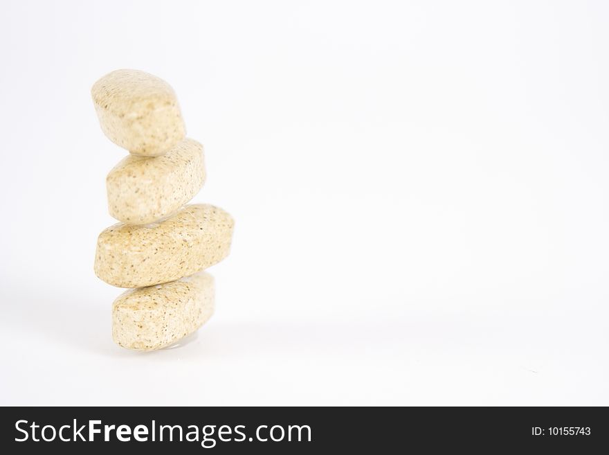 Stack of four speckled vitamin supplements. Stack of four speckled vitamin supplements