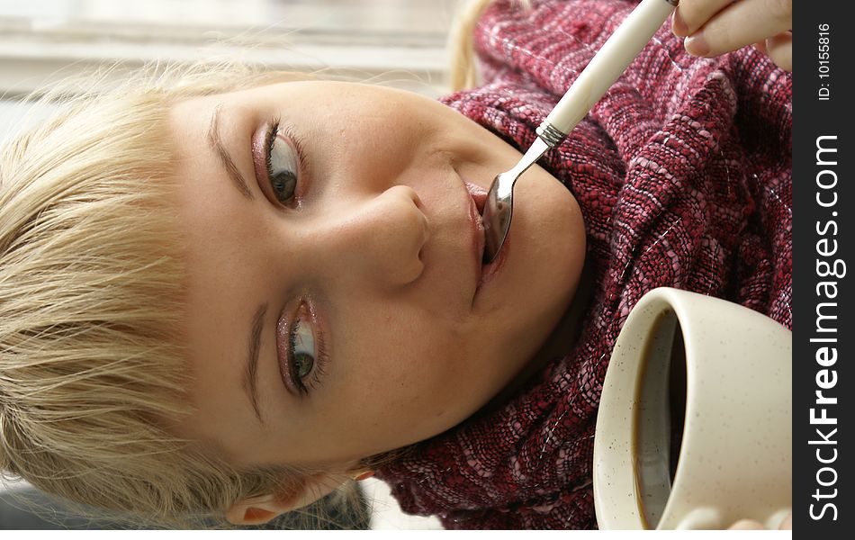 Beautiful young girl with a cup of hot coffee drink. Beautiful young girl with a cup of hot coffee drink