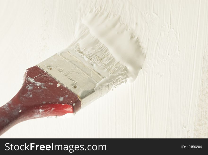 Brush Soaked In White Paint Colouring Wall