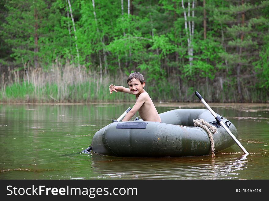 Boy in boat  at forest like