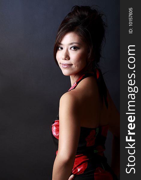 A Japanese young woman's portrait,isolated on dark background.