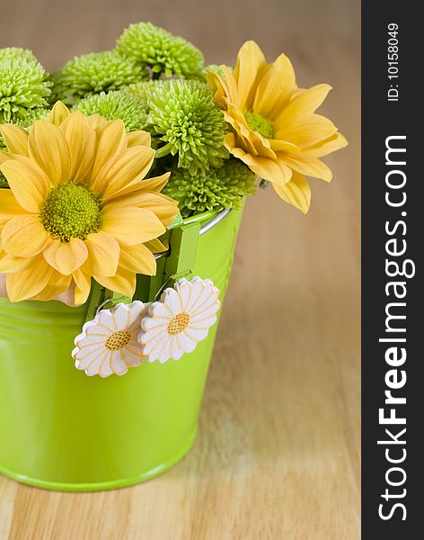 Bunch of colourful flowers arranged in little green metal bucket. Bunch of colourful flowers arranged in little green metal bucket