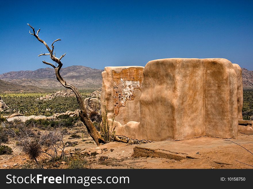 Old adobe building with the mountains in the background at Joshua Tree National State Park. Old adobe building with the mountains in the background at Joshua Tree National State Park