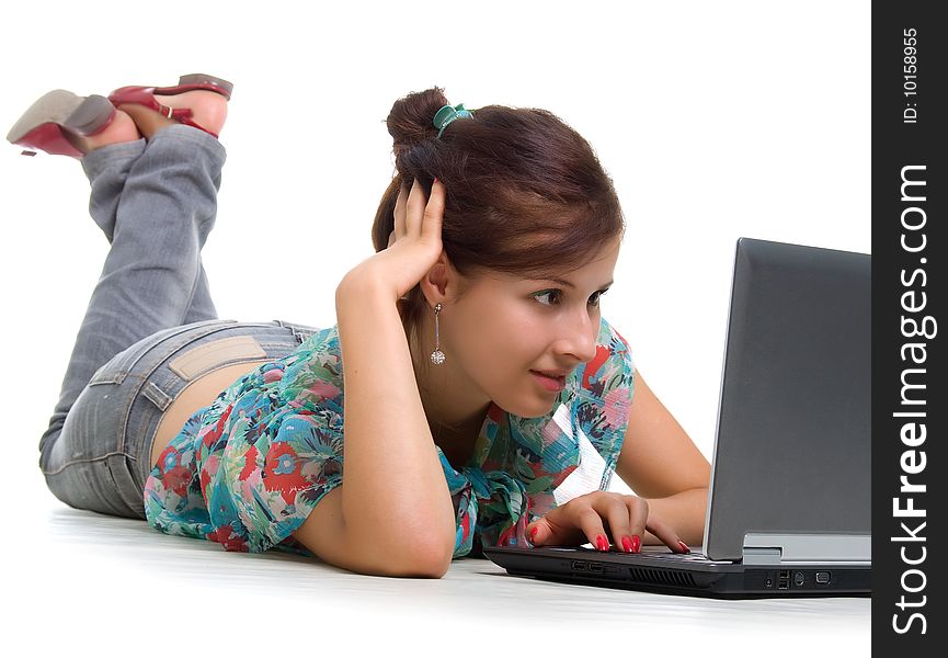 Cute young woman with laptop. Studio shot