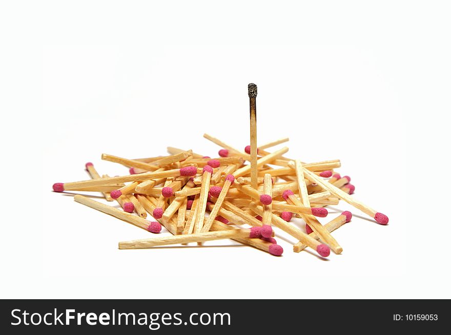 A Pile of red head matches with one single burnt out match in focus. A Pile of red head matches with one single burnt out match in focus