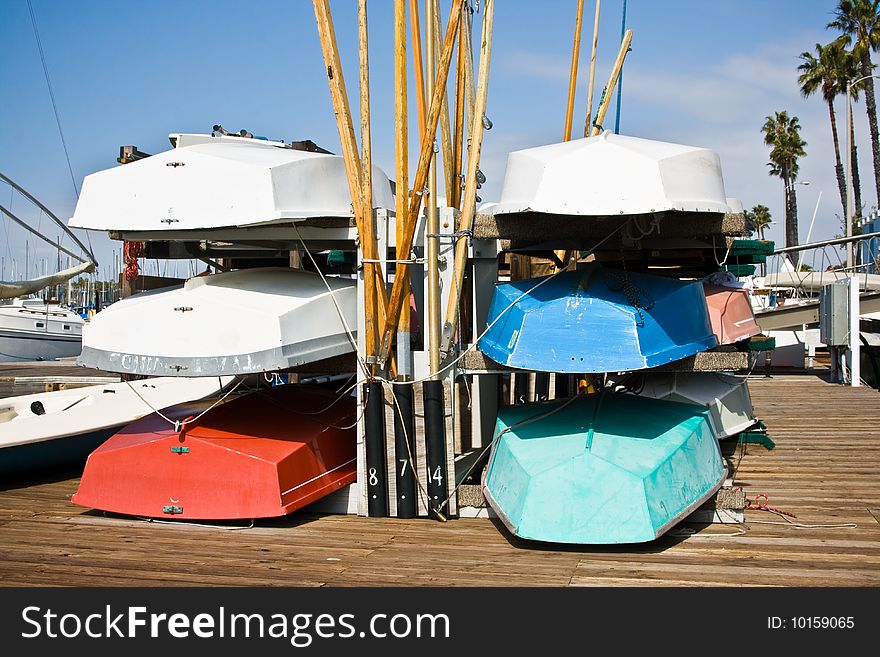 Six row boats on a dock in the Long Beach Harbor, California.