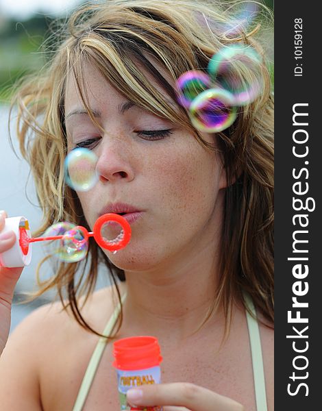 Beautiful woman is blowing bubbles. Beautiful woman is blowing bubbles