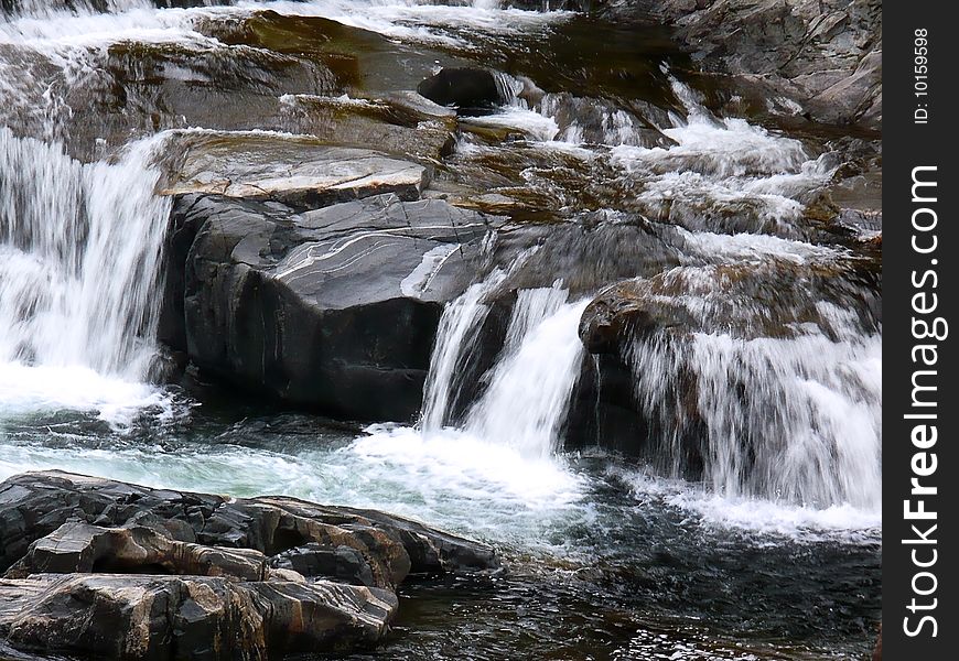 A small rocky mountain waterfall.