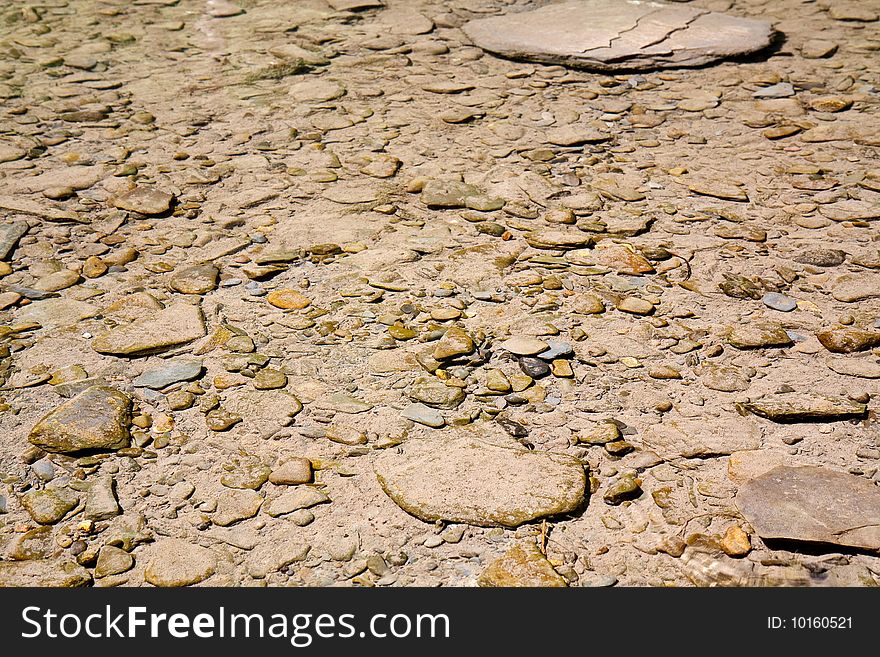 Rocks on the bottom of a shallow river, running through the mountains. Rocks on the bottom of a shallow river, running through the mountains