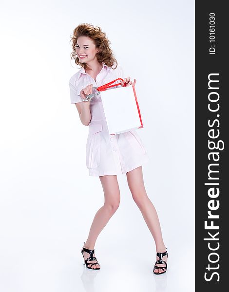 Young woman with shopping bag laughing. Young woman with shopping bag laughing