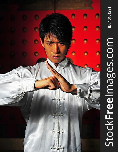 Young Asian Man In White Traditional Clothing In Oriental Theme. Young Asian Man In White Traditional Clothing In Oriental Theme