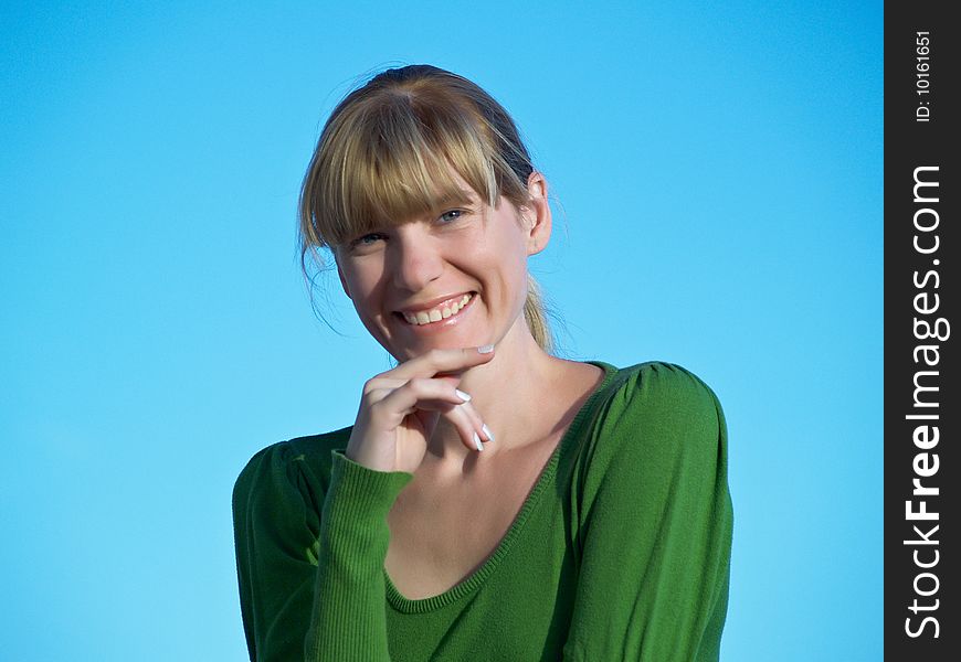 Portrait of the young woman posing on a background of the dark blue sky. Portrait of the young woman posing on a background of the dark blue sky