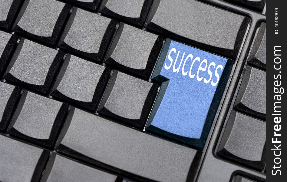 Blue success computer key on a black keyboard. Blue success computer key on a black keyboard
