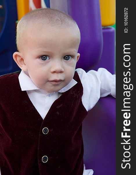 An interested little boy with big blue eyes and a bald head