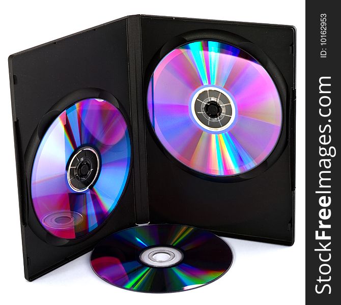 Two compact disk's in black case and one on surface. Two compact disk's in black case and one on surface