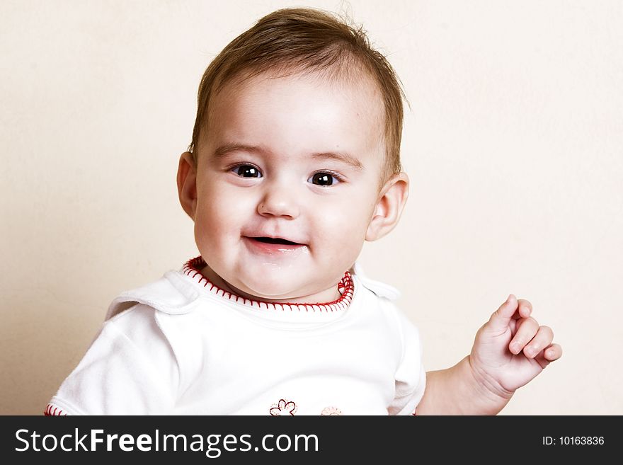 Beautiful brunette baby girl with cute facial expressions