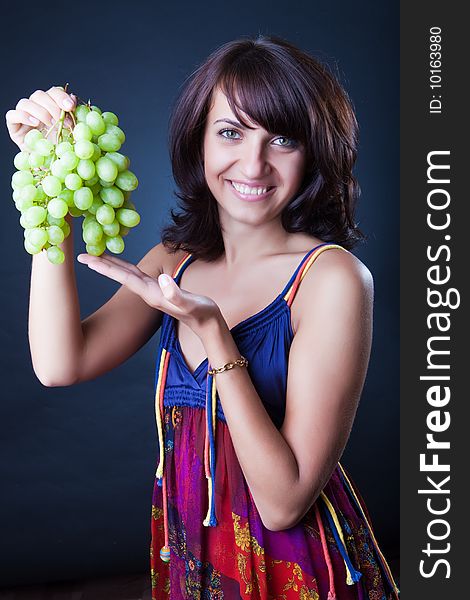 Beautiful girl with grapes cluster. Beautiful girl with grapes cluster