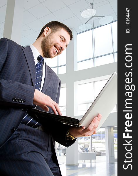 Businessman using laptop in business building