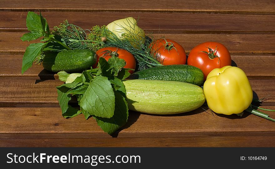 Fresh vegetables prepared for salad on wooden background. Fresh vegetables prepared for salad on wooden background