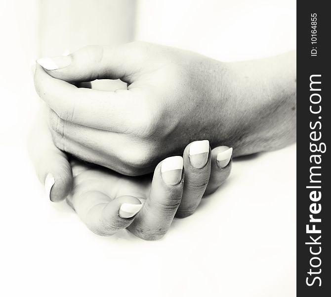 Female hands cupped into one another in sepia tone