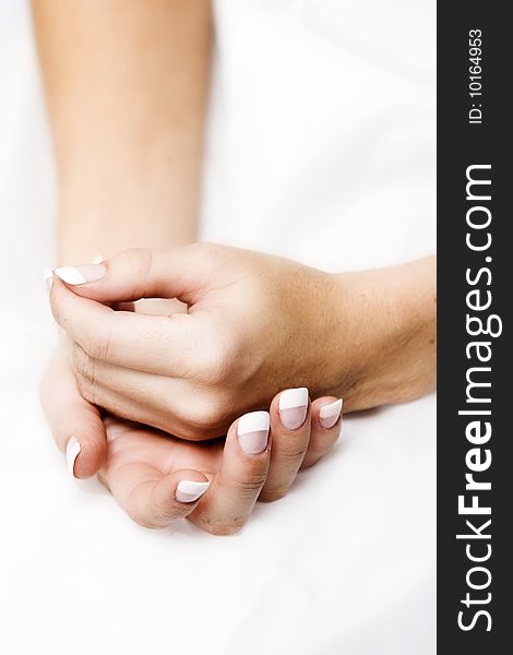 Female hands cupped into one another on white