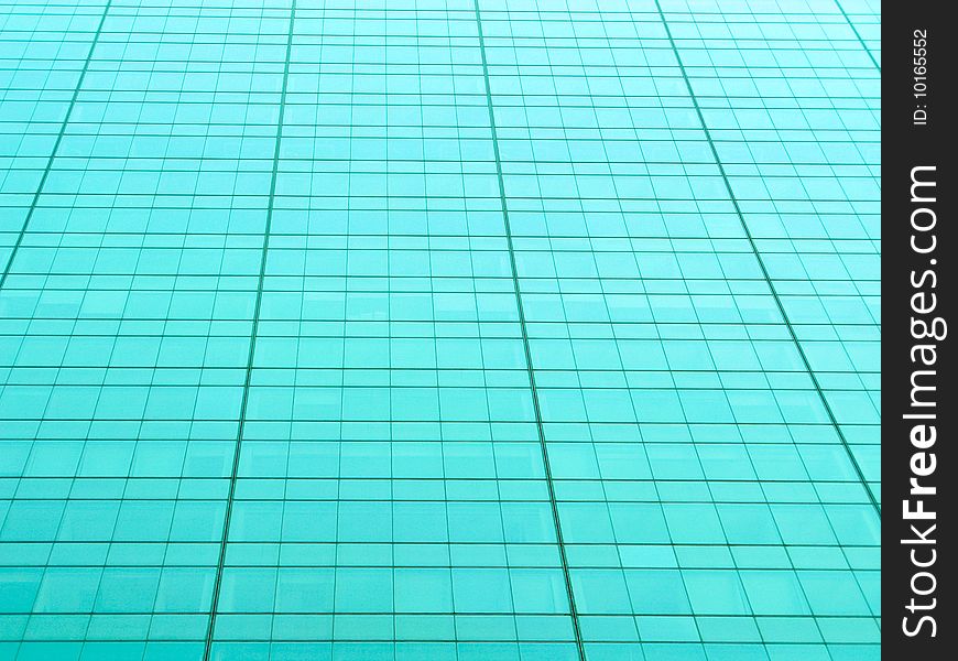 Metallic teal tinted grid from a building exterior. Metallic teal tinted grid from a building exterior