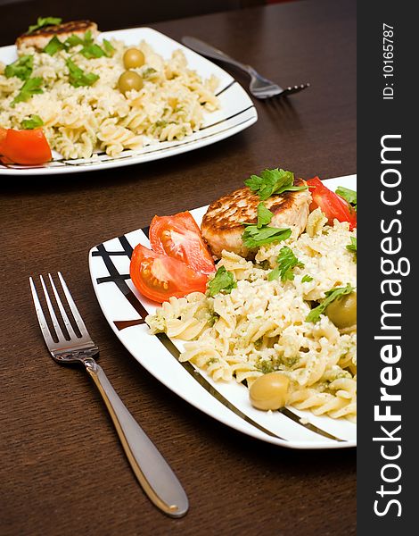 Plate of fusilli with fresh tomato and chop. Plate of fusilli with fresh tomato and chop