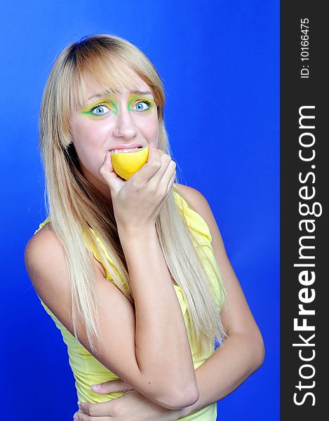 A blond girl with yellow lemon. A blond girl with yellow lemon